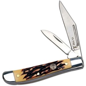 Elk Ridge Trapper EDC Knife with Clip and Wherncliffe blades shown open with a faux bone handle on a white bacground.