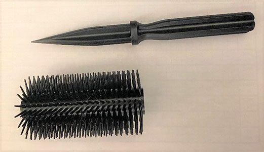 A hairbrush disguised knife shown with the blade showing.